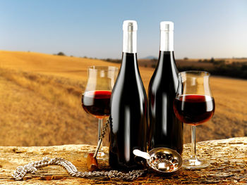 Close-up of wine bottles on glass