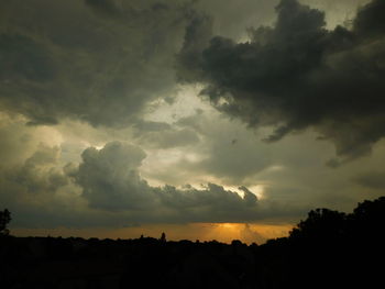 Silhouette of landscape against cloudy sky