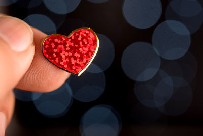 Close-up of hand holding heart shape sticker