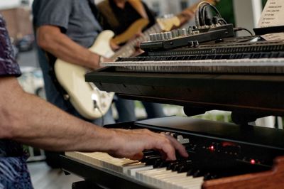 Midsection of man working at music concert