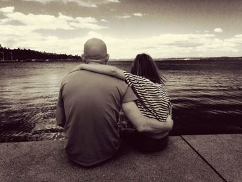 Rear view of couple looking at sea