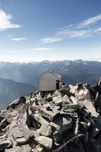 Stack of rocks on mountain against sky