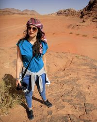 Portrait of woman standing on arid landscape