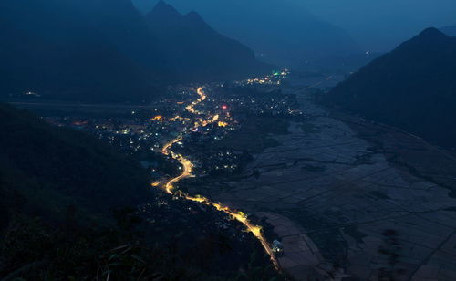 High angle view of illuminated mountain range at night