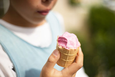 Midsection of woman holding ice cream