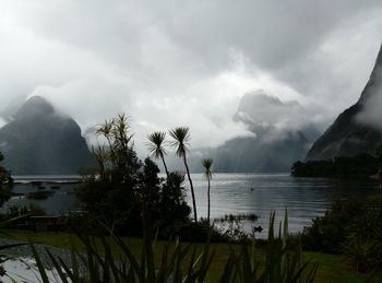 Scenic view of lake against cloudy sky