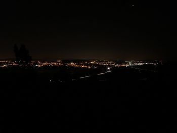 High angle view of illuminated buildings against sky at night