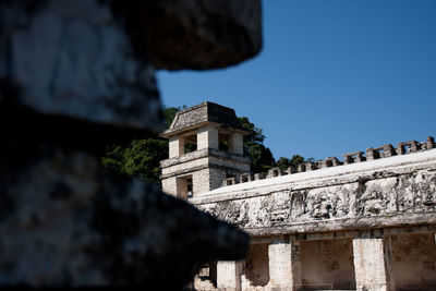 Low angle view of old building against clear blue sky