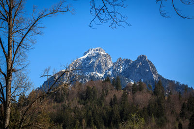 Scenic view of snowcapped mountains against blue sky