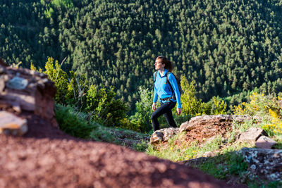 Man standing on rock in forest