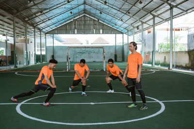 Soccer players stretching on field