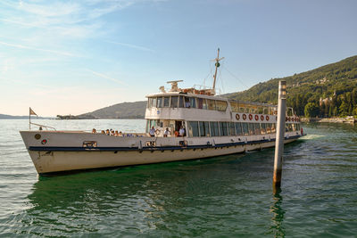 Ferryboat with tourists in navigation on the maggiore lake, piedmont, italy
