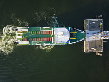 Aerial view of people boarding moored ferry