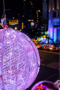 Close-up of illuminated christmas lights on street