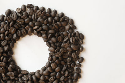 High angle view of coffee beans on white background