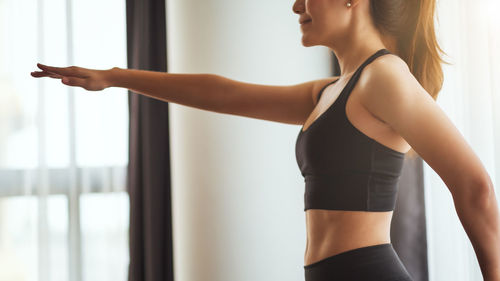 Midsection of woman exercising in gym