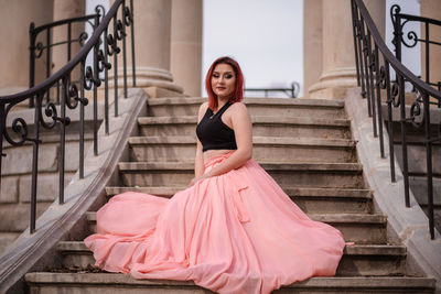 Portrait of young woman on staircase