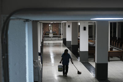 Rear view of woman walking on railroad station