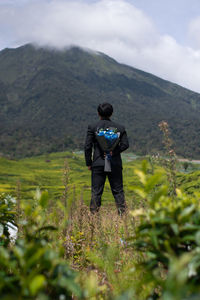 Rear view of man standing on mountain