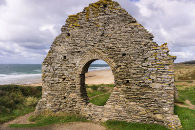 View of old ruin building against cloudy sky