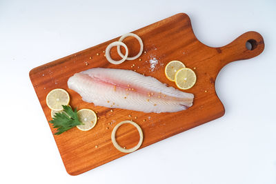 High angle view of fish on cutting board