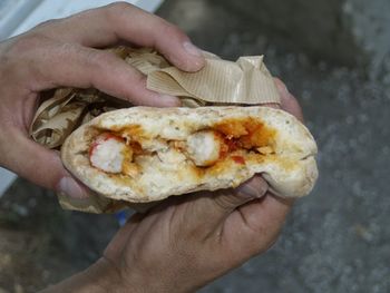 Close-up of cropped hand holding food