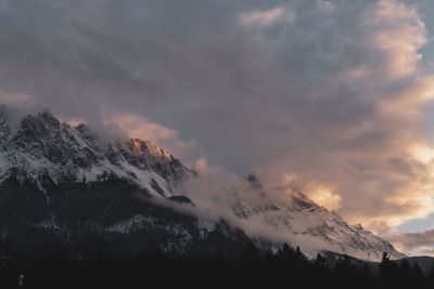 Scenic view of snowcapped mountains against sky during sunset