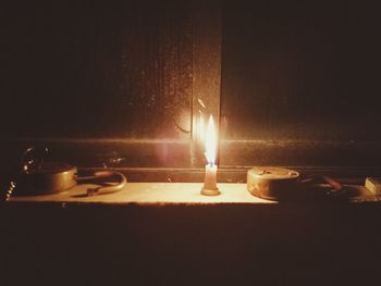 Close-up of illuminated lamp on table