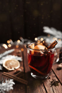 Glass cup of mulled wine on wooden table and background. christmas time concept