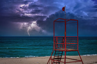 Beach during the storm with lightning and dramatic cloudy sky