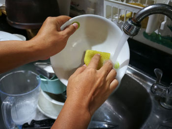 Midsection of person preparing food in kitchen at home