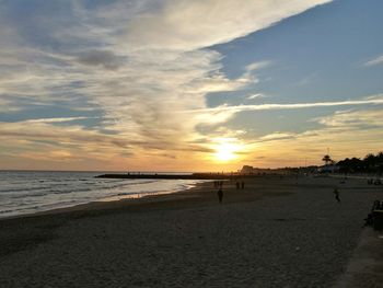 Scenic view of beach against sky during sunset