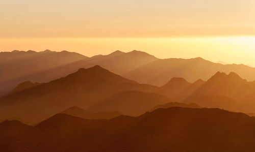 Scenic view of mountains against sky during sunset