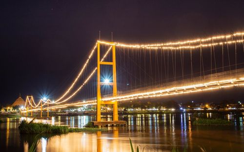 Illuminated suspension bridge at night