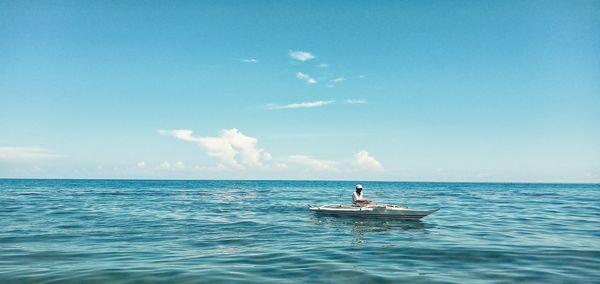 Man in sea against sky