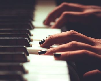 Close-up of person playing piano