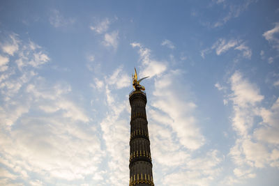 Low angle view of building against cloudy sky