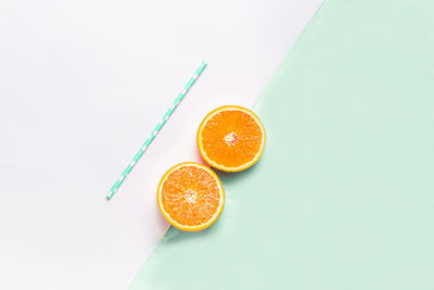 High angle view of orange slice against white background