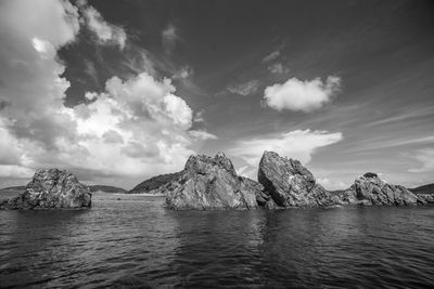 Scenic view of sea and mountains against sky
