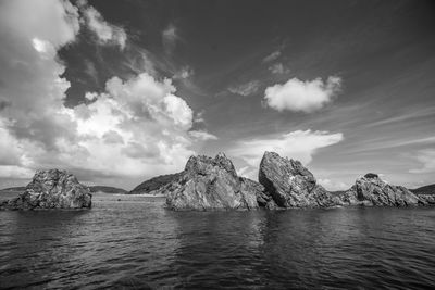 Scenic view of sea and mountains against sky