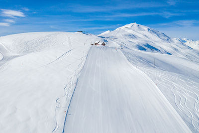 Scenic view of snow covered mountain against sky