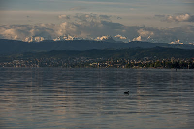 Scenic view of lake against sky at sunset