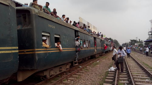 People walking on railroad station platform