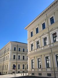 Low angle view of building against clear blue sky