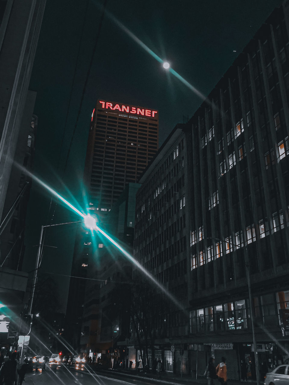 LOW ANGLE VIEW OF ILLUMINATED BUILDING AT NIGHT