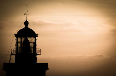 Low angle view of silhouette tower against sky during sunset