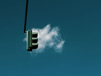Low angle view of street light against blue sky