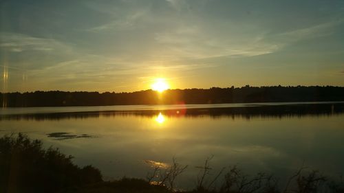 Scenic view of calm lake at sunset