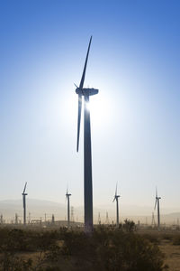 Windmill on field against clear sky