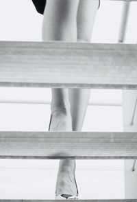 Low section of woman standing on staircase